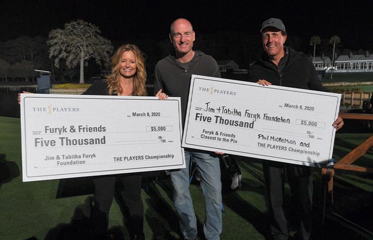 Furyk & Friends holding check