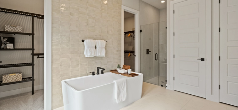 Modern Master Bathroom with Freestanding Tub Modern bathroom with freestanding tub, glass shower, and neutral tile.