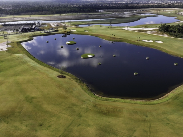 aerial of lake with floating golf greens 