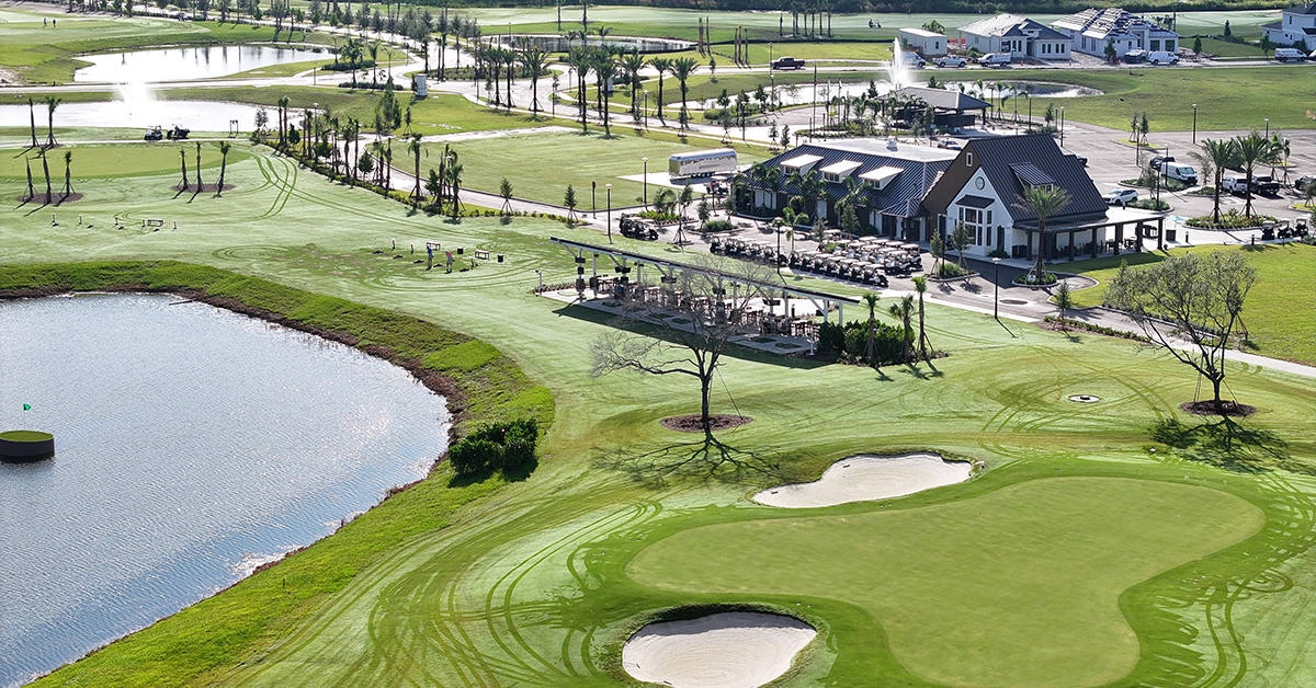 Aerial view of the Toptracer aquatic driving range at Glynlea Country Club with water targets and clubhouse amenities.