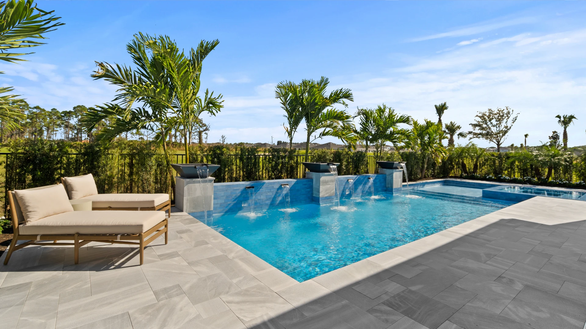 Luxury backyard pool with palm trees