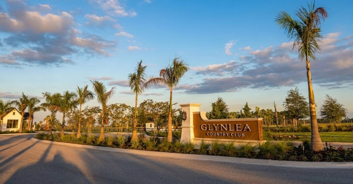 Glynlea Country Club entrance sign with palm trees at sunset