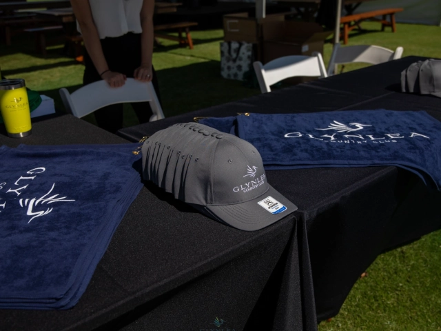 Golfer carrying bag past event tents