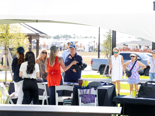 People gathered at outdoor registration table