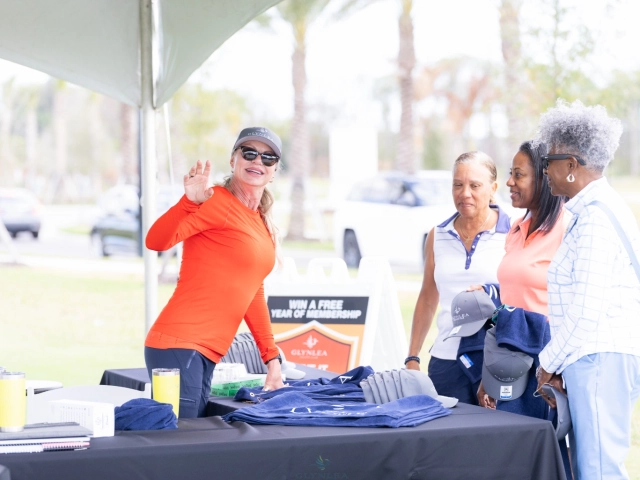 Women browsing merchandise at event table