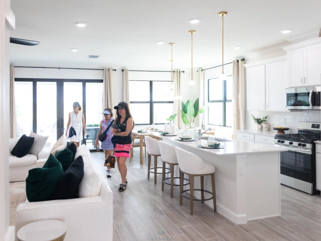 Visitors touring open kitchen and living room